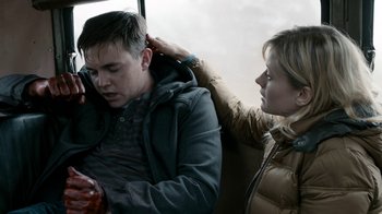 Movie still from “Chernobyl Diaries” (2012), directed by Bradley Parker – A man and a woman on a bus; Medium shot, Over the shoulder angle