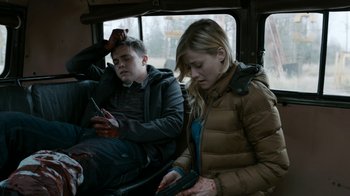 Movie still from “Chernobyl Diaries” (2012), directed by Bradley Parker – A man and a woman sitting in a car; Medium shot, High angle