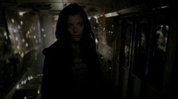 Movie still from “Chernobyl Diaries” (2012), directed by Bradley Parker – A woman standing in the dark in a dark room; Medium shot, Low angle