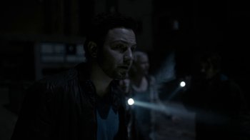 Movie still from “Chernobyl Diaries” (2012), directed by Bradley Parker – A man standing next to another man in the dark; Close Up shot, Over the shoulder angle