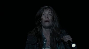 Movie still from “Chernobyl Diaries” (2012), directed by Bradley Parker – A woman with blood all over her face; Medium shot, Over the shoulder angle