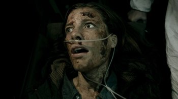 Movie still from “Chernobyl Diaries” (2012), directed by Bradley Parker – A woman with a string attached to her face; Close Up shot, Overhead angle