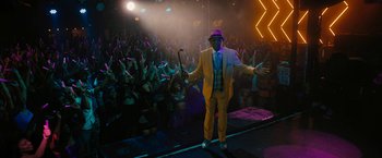 Movie still from “Chi-Raq” (2015), directed by Spike Lee – A man in a yellow suit standing in front of a crowd; Wide shot, High angle