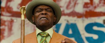 Movie still from “Chi-Raq” (2015), directed by Spike Lee – An older man in a hat and a suit; Close Up shot, Low angle