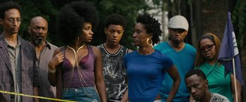 Movie still from “Chi-Raq” (2015), directed by Spike Lee – A group of people standing next to each other on the street; Medium shot, Over the shoulder angle