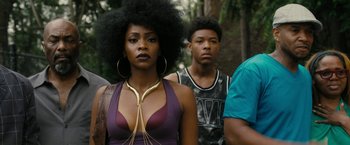 Movie still from “Chi-Raq” (2015), directed by Spike Lee – A group of people standing next to each other on a street; Close Up shot, Over the shoulder angle