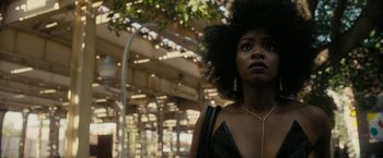Movie still from “Chi-Raq” (2015), directed by Spike Lee – A woman in a black dress and a gold necklace; Close Up shot, Low angle