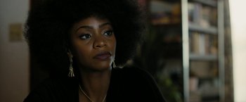 Movie still from “Chi-Raq” (2015), directed by Spike Lee – A person wearing a black shirt; Close Up shot, Over the shoulder angle