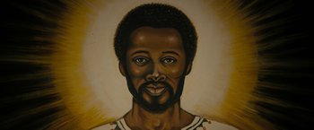 Movie still from “Chi-Raq” (2015), directed by Spike Lee – A painting of a black man with a beard; Close Up shot, High angle