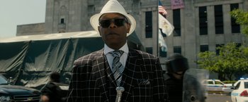 Movie still from “Chi-Raq” (2015), directed by Spike Lee – A man wearing a white hat and a suit; Close Up shot, Low angle