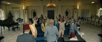 Movie still from “Chi-Raq” (2015), directed by Spike Lee – A group of people standing in front of a wall; Wide shot, Over the shoulder angle
