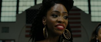 Movie still from “Chi-Raq” (2015), directed by Spike Lee – A person wearing big gold earrings; Close Up shot, Over the shoulder angle