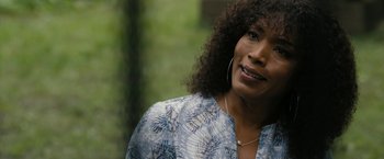 Movie still from “Chi-Raq” (2015), directed by Spike Lee – A person wearing a blue and white shirt; Close Up shot, Over the shoulder angle