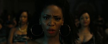 Movie still from “Chi-Raq” (2015), directed by Spike Lee – A person wearing big earrings; Close Up shot, Low angle