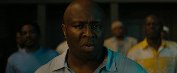 Movie still from “Chi-Raq” (2015), directed by Spike Lee – A person wearing a blue shirt; Close Up shot, Low angle