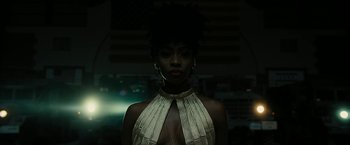 Movie still from “Chi-Raq” (2015), directed by Spike Lee – A woman in a gold dress with a black afro hair style; Close Up shot, Low angle