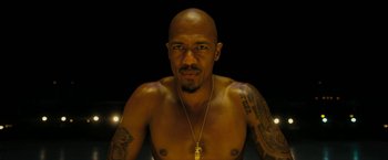 Movie still from “Chi-Raq” (2015), directed by Spike Lee – A bald man with a beard and a gold necklace; Close Up shot, Low angle