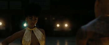 Movie still from “Chi-Raq” (2015), directed by Spike Lee – A woman standing in front of a car at night; Close Up shot, Over the shoulder angle