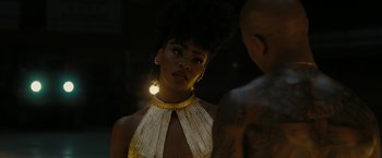 Movie still from “Chi-Raq” (2015), directed by Spike Lee – A woman in a yellow dress is looking at a man in a black shirt; Close Up shot, Over the shoulder angle