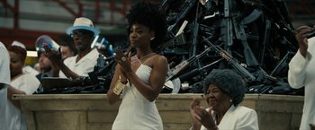 Movie still from “Chi-Raq” (2015), directed by Spike Lee – A woman clapping her hands in front of an audience; Medium shot, Over the shoulder angle