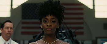 Movie still from “Chi-Raq” (2015), directed by Spike Lee – A person with a flag in the background; Close Up shot, Low angle
