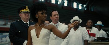 Movie still from “Chi-Raq” (2015), directed by Spike Lee – A woman in a white dress holding a knife in her hand; Medium shot, Over the shoulder angle
