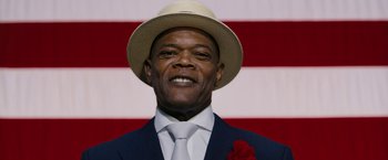 Movie still from “Chi-Raq” (2015), directed by Spike Lee – A person wearing a suit and a hat; Close Up shot, Low angle
