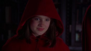Movie still from “Chocolat” (2000), directed by Lasse Hallström – A young girl wearing a red hooded jacket; Close Up shot, High angle
