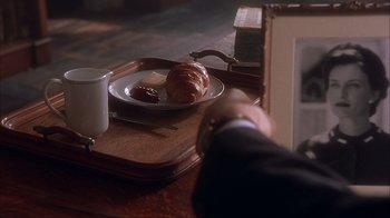Movie still from “Chocolat” (2000), directed by Lasse Hallström – A person is holding a tray with a plate of food on top of it; Extreme Close Up shot, High angle