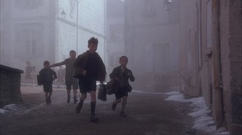 Movie still from “Chocolat” (2000), directed by Lasse Hallström – A group of young boys running through the fog; Wide shot, High angle