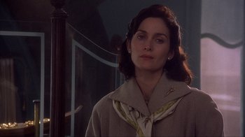 Movie still from “Chocolat” (2000), directed by Lasse Hallström – A woman in a beige coat and a yellow scarf; Close Up shot, Over the shoulder angle