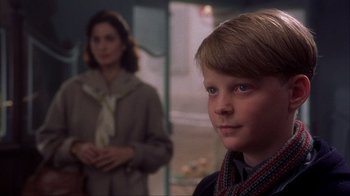 Movie still from “Chocolat” (2000), directed by Lasse Hallström – A young boy and a woman in a room; Close Up shot, Over the shoulder angle