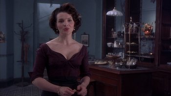 Movie still from “Chocolat” (2000), directed by Lasse Hallström – A woman standing in front of a buffet table; Medium shot, Low angle