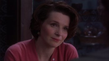 Movie still from “Chocolat” (2000), directed by Lasse Hallström – A person wearing a pink sweater; Close Up shot, Over the shoulder angle