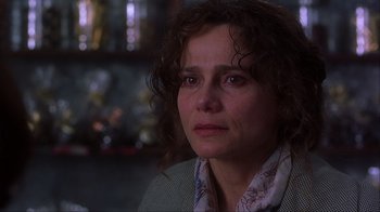 Movie still from “Chocolat” (2000), directed by Lasse Hallström – A person with curly hair; Close Up shot, Over the shoulder angle