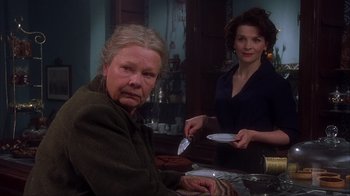 Movie still from “Chocolat” (2000), directed by Lasse Hallström – Two women are sitting at a table with plates; Medium shot, Low angle