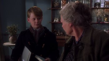 Movie still from “Chocolat” (2000), directed by Lasse Hallström – An older woman and a young boy in a room; Close Up shot, Over the shoulder angle