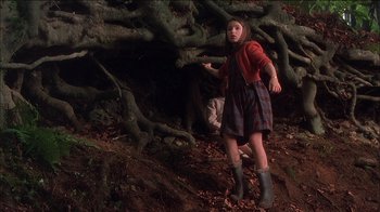 Movie still from “Chocolat” (2000), directed by Lasse Hallström – A young girl standing in front of a large tree; Wide shot, Low angle