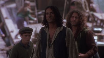 Movie still from “Chocolat” (2000), directed by Lasse Hallström – A group of men standing next to each other; Medium shot, Over the shoulder angle