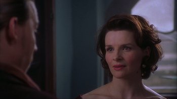 Movie still from “Chocolat” (2000), directed by Lasse Hallström – A person looking at a mirror; Close Up shot, Over the shoulder angle