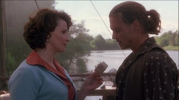 Movie still from “Chocolat” (2000), directed by Lasse Hallström – A man and a woman looking at each other; Medium shot, Over the shoulder angle