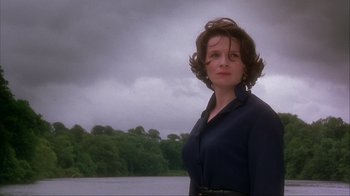 Movie still from “Chocolat” (2000), directed by Lasse Hallström – A woman standing in front of a body of water; Medium shot, Low angle