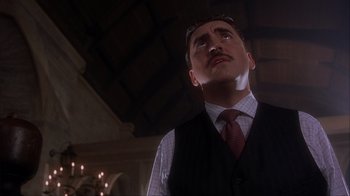 Movie still from “Chocolat” (2000), directed by Lasse Hallström – A man in a vest and tie looking up at the ceiling; Close Up shot, Low angle