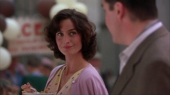 Movie still from “Chocolat” (2000), directed by Lasse Hallström – A person wearing a suit and tie; Close Up shot, Over the shoulder angle