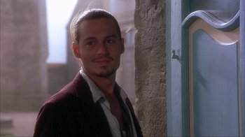 Movie still from “Chocolat” (2000), directed by Lasse Hallström – A person wearing a suit and tie; Close Up shot, Over the shoulder angle
