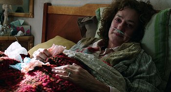 Movie still from “Chronicle” (2012), directed by Josh Trank – An older woman laying in a bed with a crocheted blanket; Close Up shot, High angle
