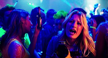 Movie still from “Chronicle” (2012), directed by Josh Trank – A woman in a crowd of people holding a camera; Close Up shot, Low angle