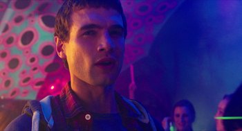 Movie still from “Chronicle” (2012), directed by Josh Trank – A young man in a red plaid shirt in a room; Close Up shot, Over the shoulder angle