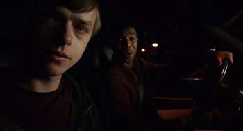 Movie still from “Chronicle” (2012), directed by Josh Trank – Two young men sitting in the back seat of a car at night; Close Up shot, Over the shoulder angle