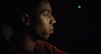 Movie still from “Chronicle” (2012), directed by Josh Trank – A young man looking to his left in the dark; Close Up shot, Over the shoulder angle